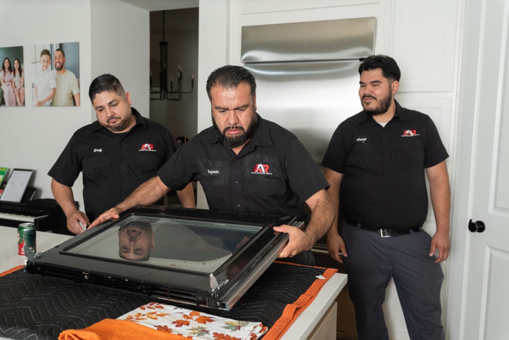 Action Appliance Repair team servicing an oven
