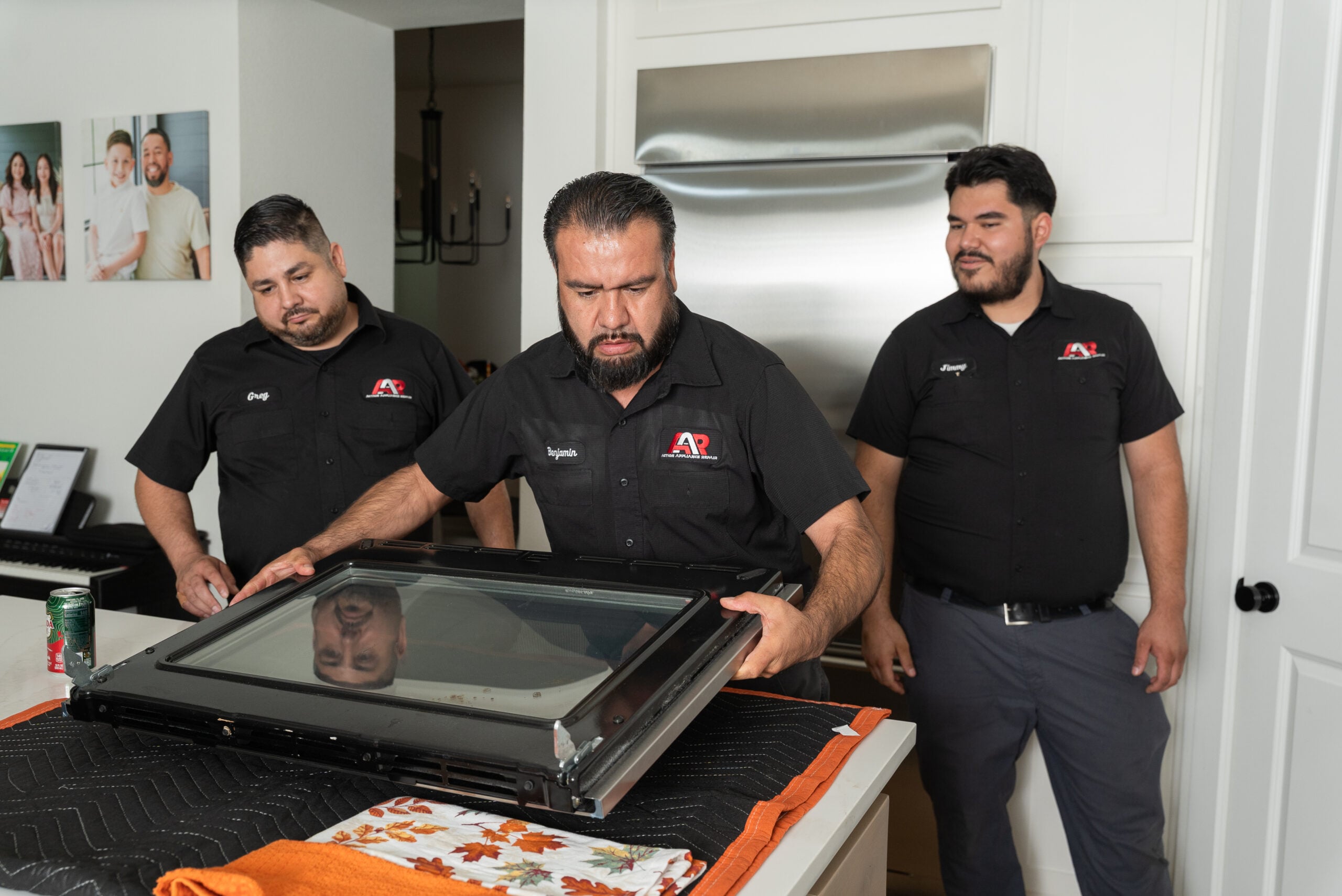 Action Appliance Repair team servicing an oven