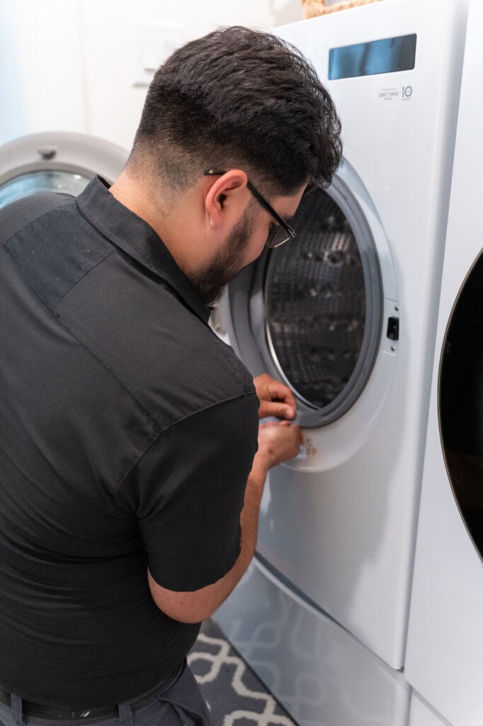 Technician replacing a washer door gasket